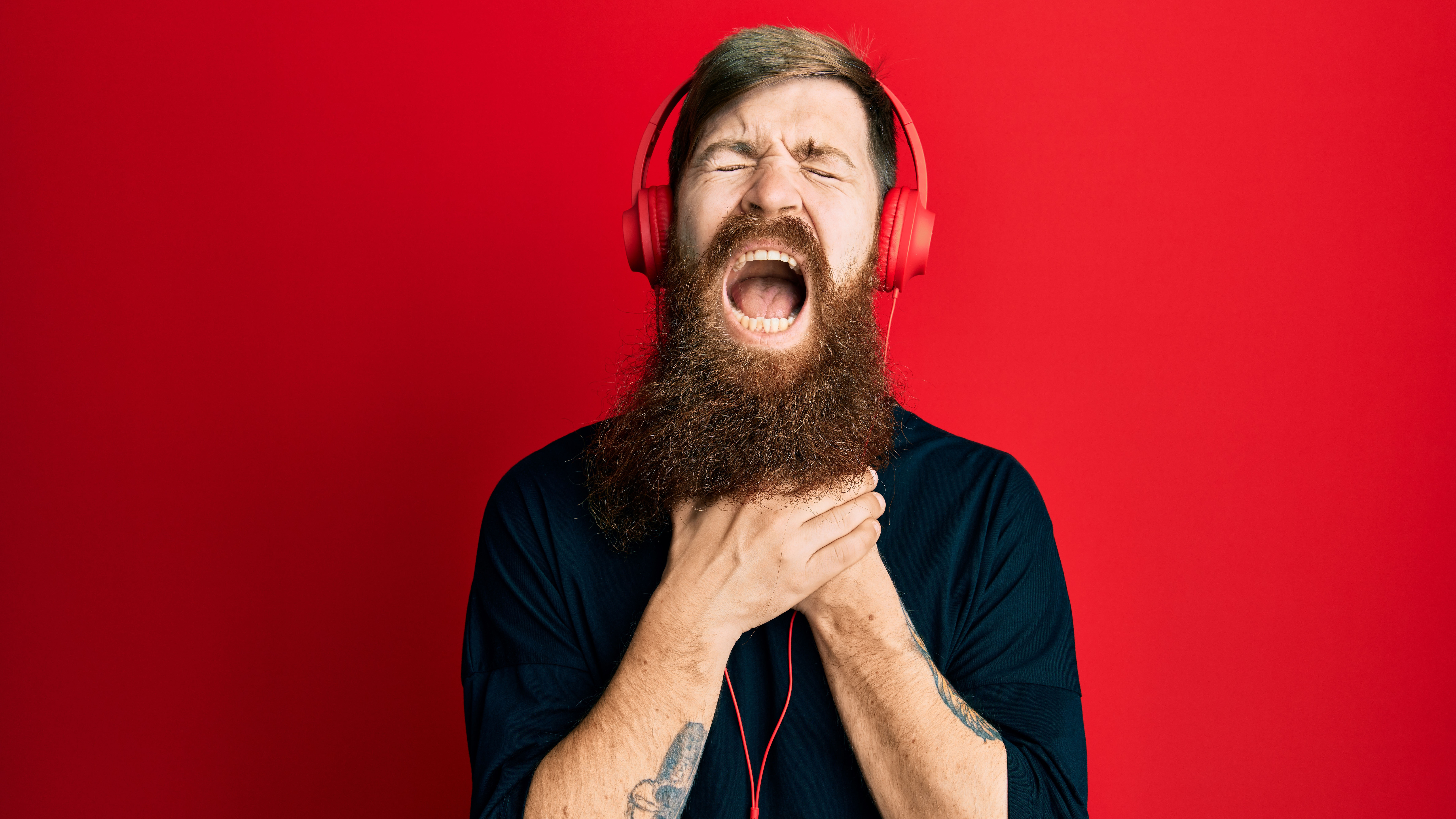 Man using headphones in pain.