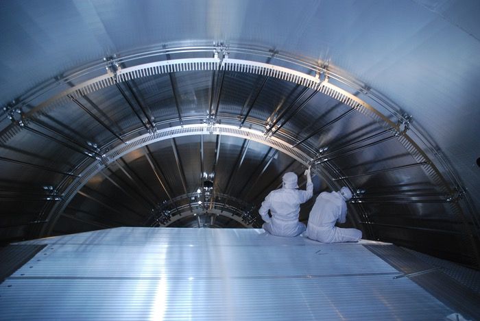 Technicians mount electrodes in the main spectrometer of the KATRIN neutrino experiment.