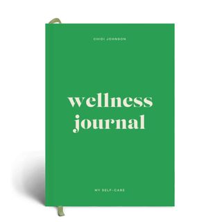A green Papier wellness journal on a white background.