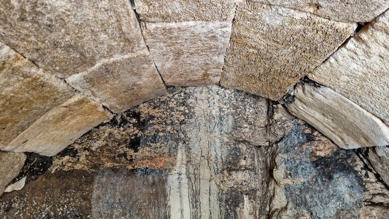 Close up of a vaulted stone ceiling. Marks show where it was filled with water.