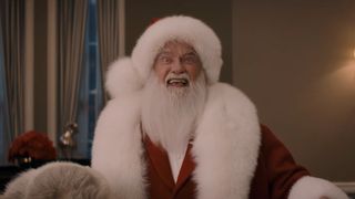 Arnold Schwarzenegger in Santa's suit saying "I'm Back" in the teaser for The Man with the Bag. 