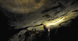 Hand fluting in the Cave of a Hundred Mammoths in France.