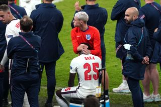 Saka is consled by England team-mate Phil Foden soon after his penalty miss at Wembley