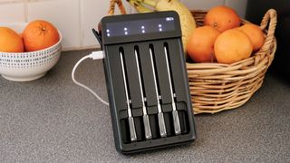 GoveeLife Smart Wireless Meat Thermometer on a kitchen counter charging next to a basket of oranges