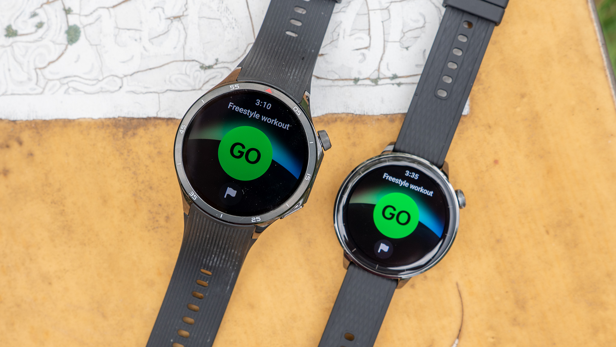 The OnePlus Watch 3 and OnePlus Watch 3 43mm next to each other, about to track a workout