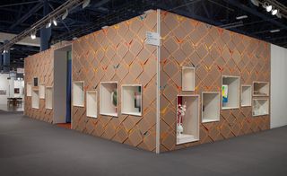 Other artists' work is encased in the shelving system Pardo has created around the outside of the gallery's booth.