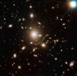 The galaxy cluster Abell 383 (at the center of this image) is so massive that it bends the light from objects behind it, acting as a cosmic magnifying glass.