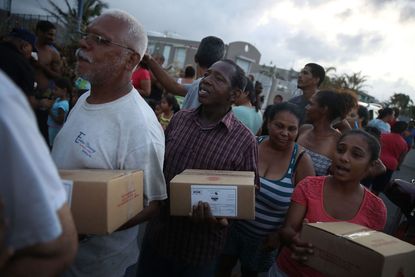 Puerto Ricans stand in line for food and water in September.