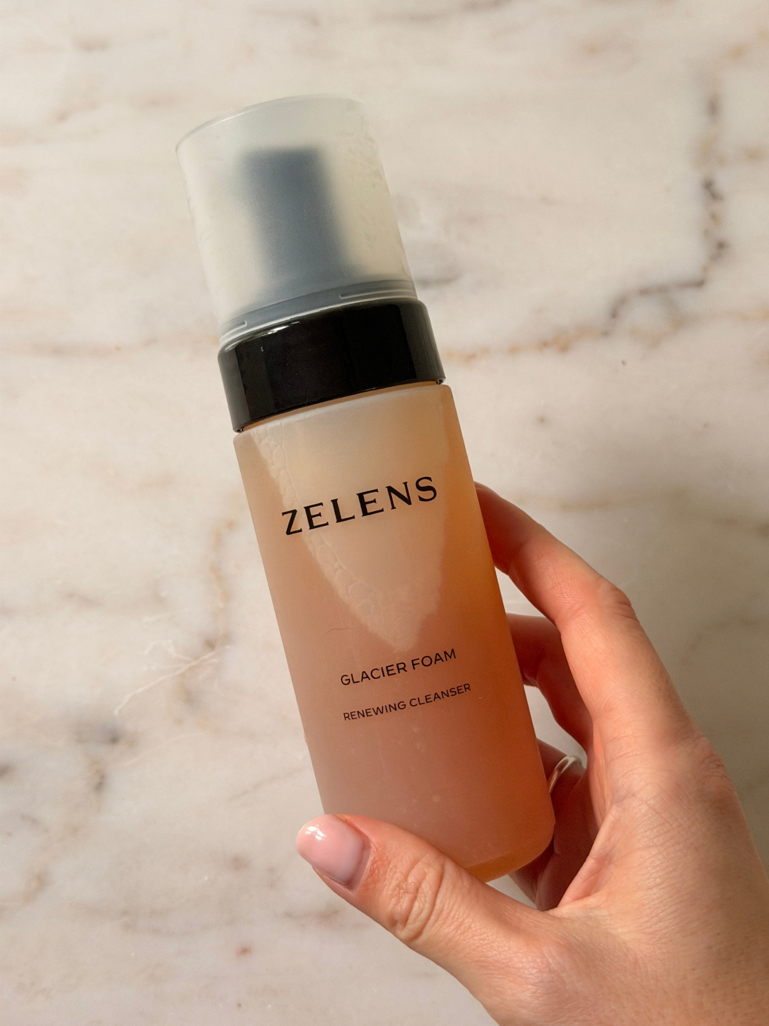 Freelance beauty editor Grace Day holding a bottle of zelens cleanser