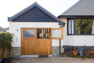 Garage converted into a home office seen from the exterior by Bliss Interiors