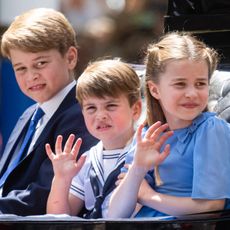 Prince George, Princess Charlotte, and Prince Louis ride in the carriage procession at Trooping the Colour