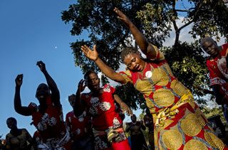 Men and women perform traditional Malawi dance