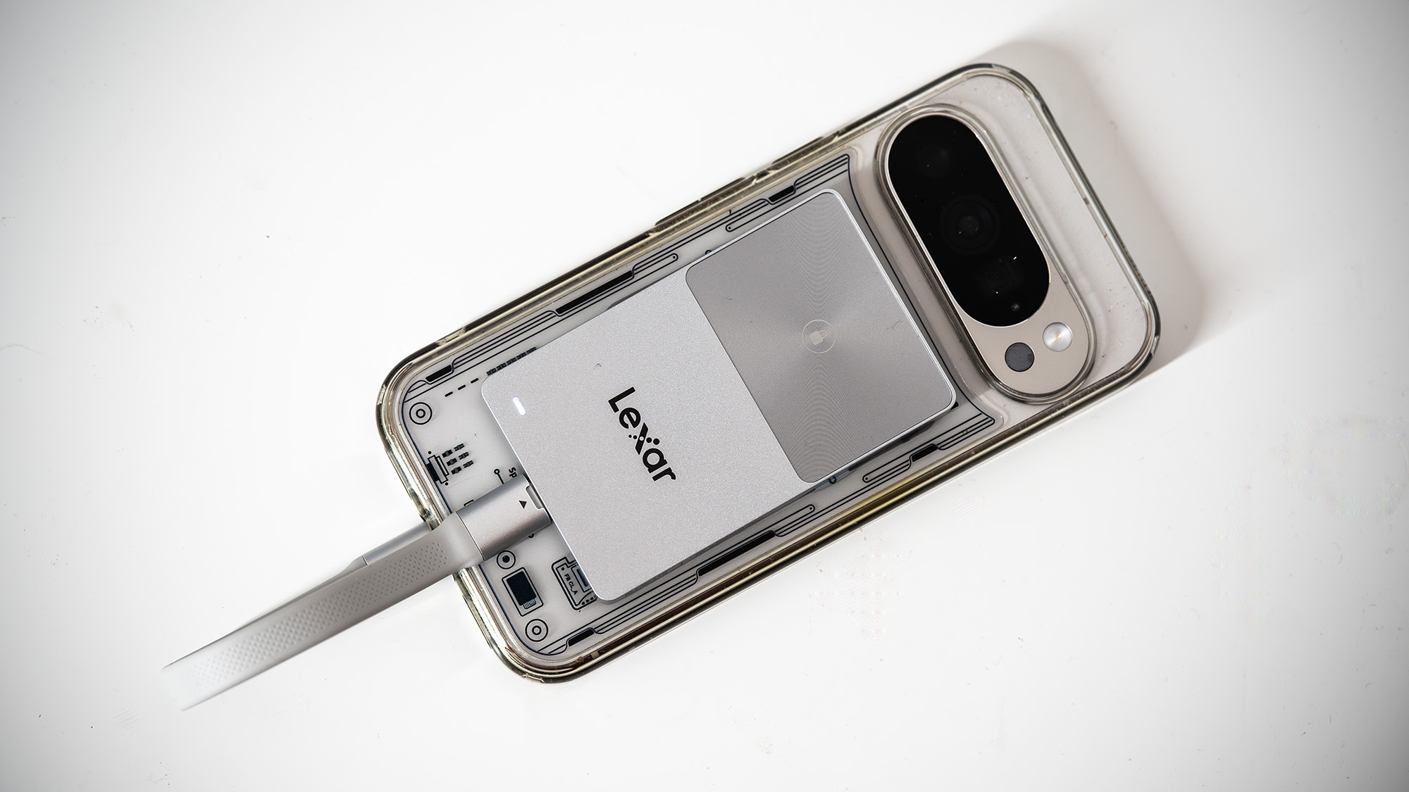Lexar TouchLock Portable SSD on a white table with a phone.