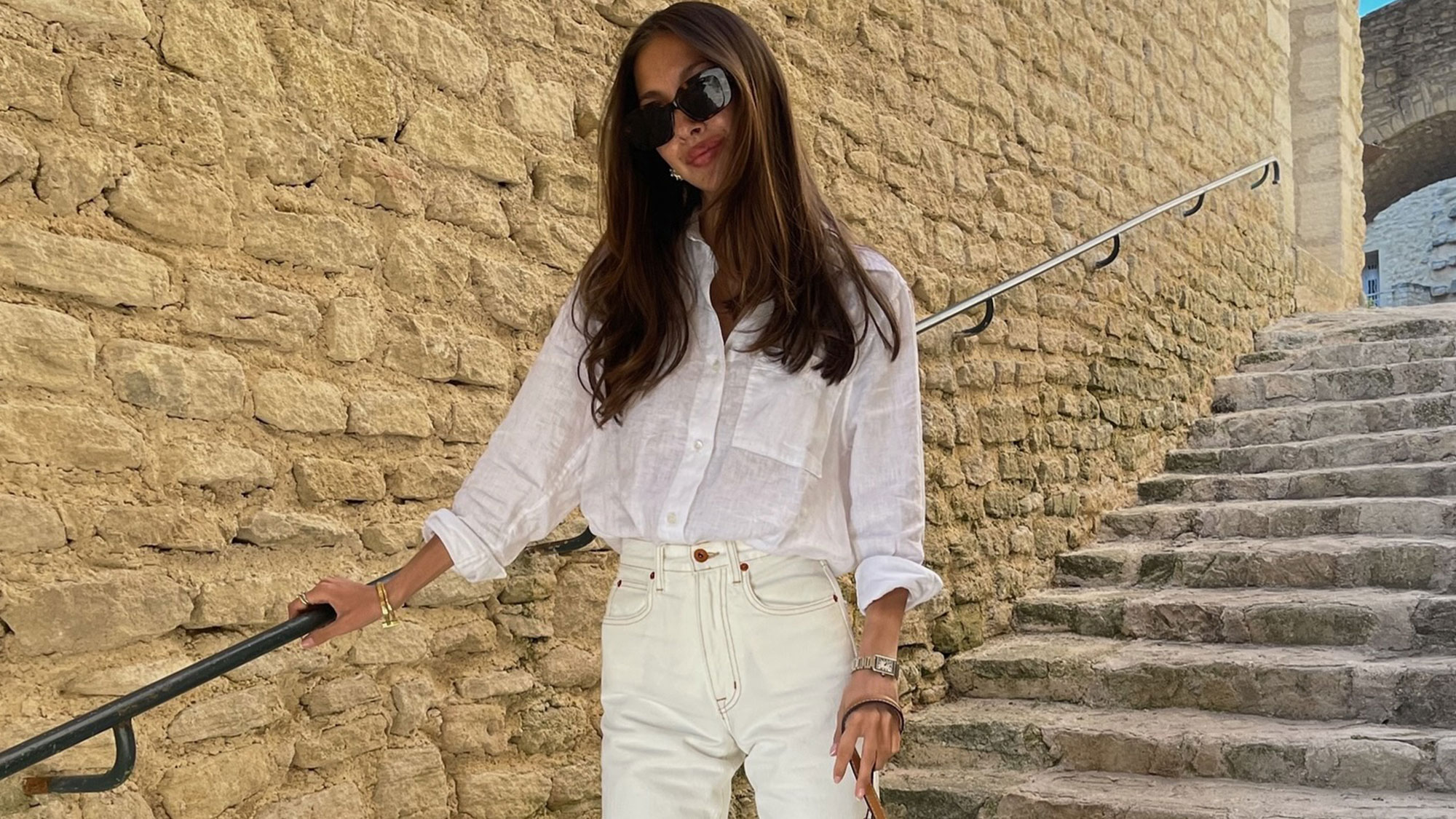 A fashion girl in a white linen top and white jeans