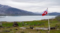 Greenland flag flies over the village of Igaliku