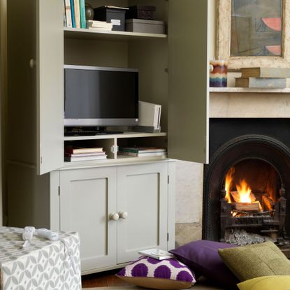 living room with fireplace and tv on cupboard