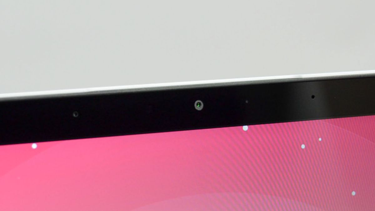 An HP Dragonfly Pro Chromebook on a ruled pink desk mat