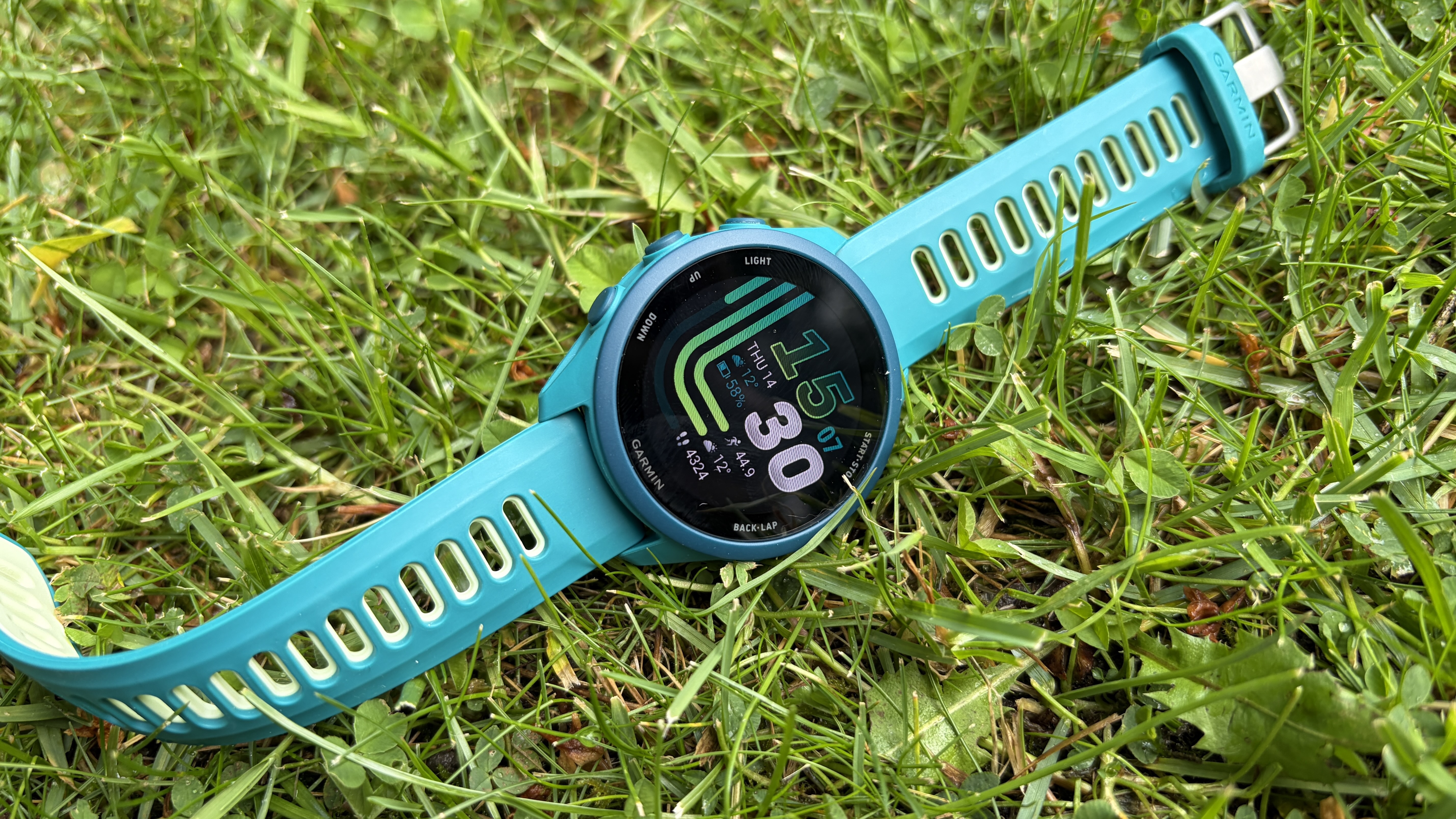 Garmin Forerunner 170 laid out on grass outside