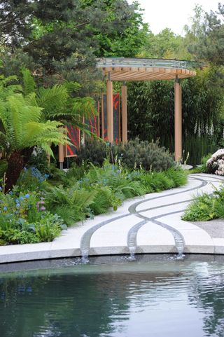 garden pond ideas: modern pond with water channels through paving