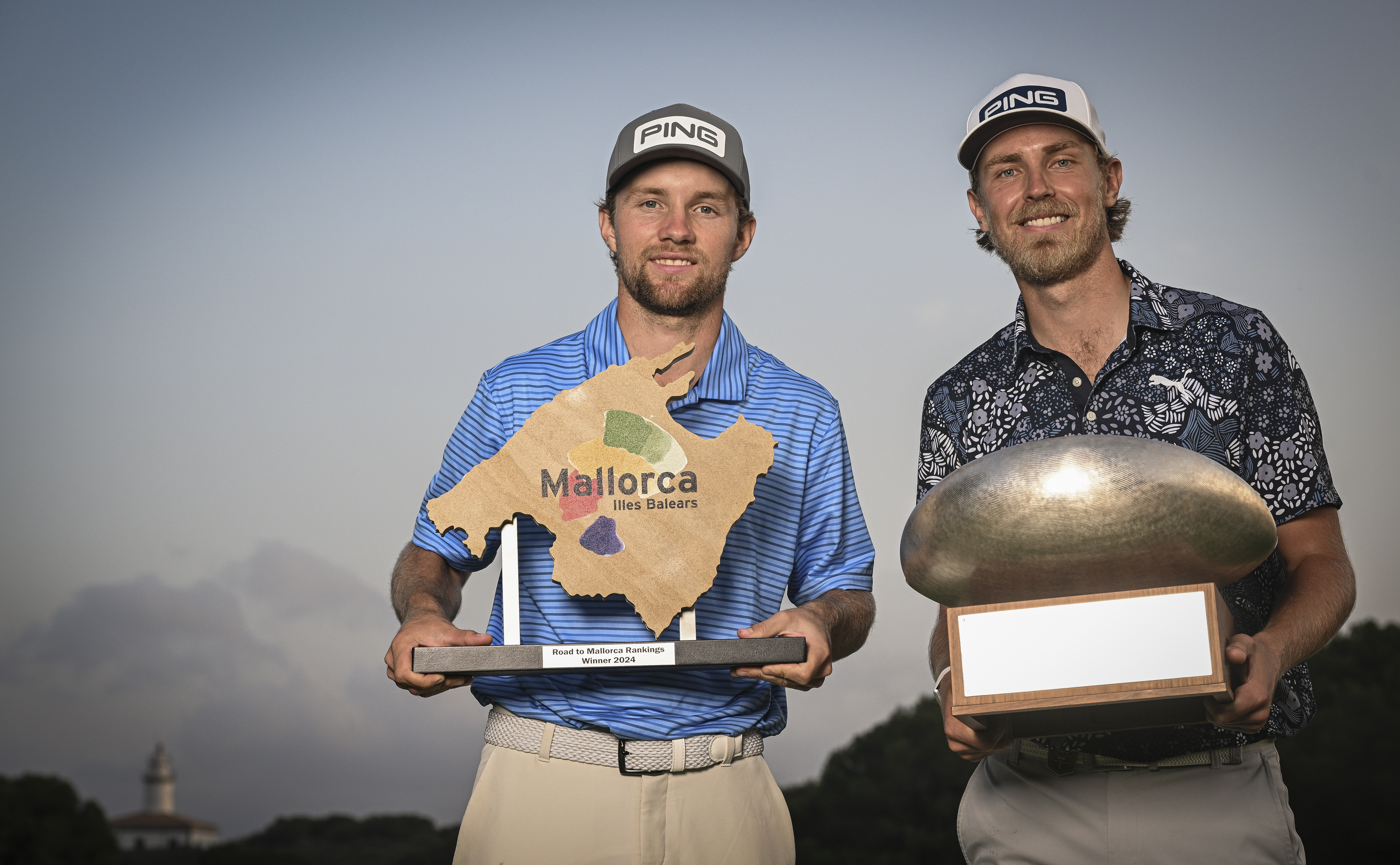 Rasmus Neergaard-Petersen (left) and Kristoffer Reitan poses with the Race To Mallorca and Challenge Tour Grand Final trophies
