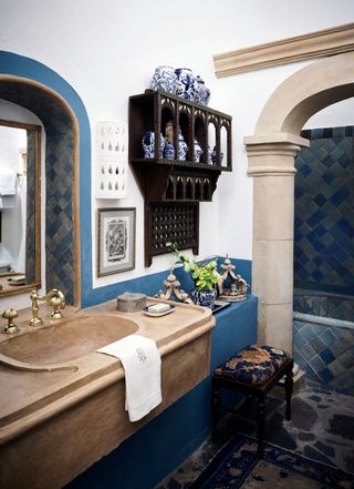 Blue tiled bathtub and brown sink