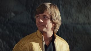 Mark Hamill looking over to the side with a smile in Star Wars: A New Hope.