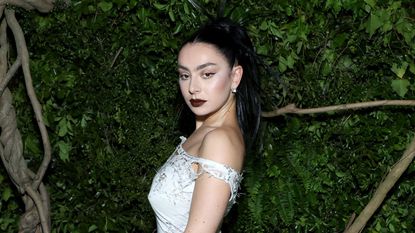 charli xcx on a green background at the met gala