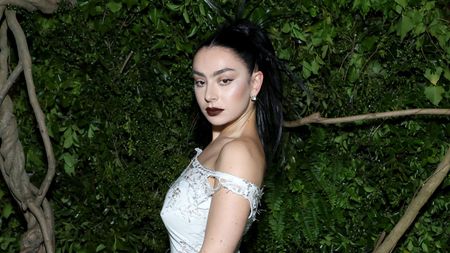 charli xcx on a green background at the met gala