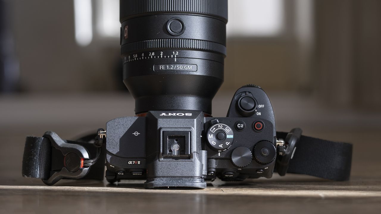 The Sony A7R V camera sitting on a wooden floor