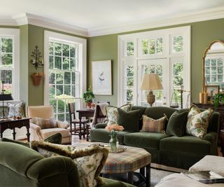 traditional living room with green walls and sofas