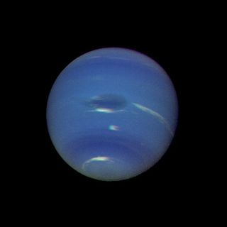 The deep blue atmosphere of Neptune is more active than Uranus' atmosphere.