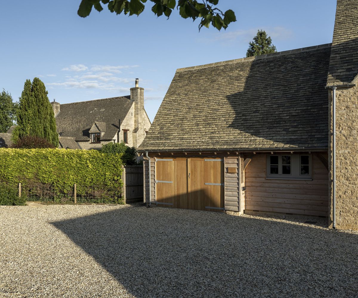 A garage building attached to the side of a newly built oak frame home