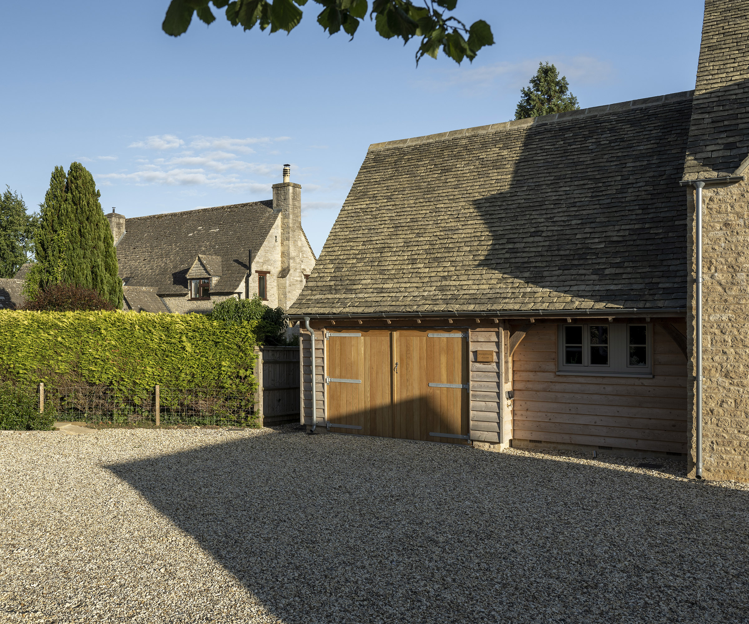 A garage building attached to the side of a newly built oak frame home