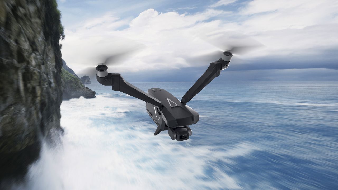 V-Copter Falcon Mini drone in flight over the ocean, next to a cliff