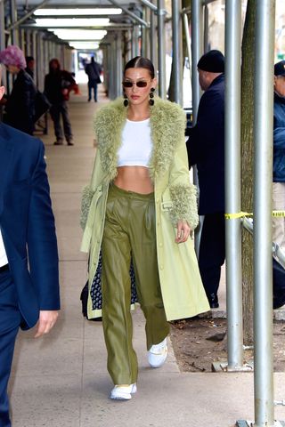 Bella Hadid wearing a Saks Potts coat with a crop top and coordinating pants in New York City