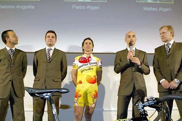 Gilberto Simoni stands alongside DS Pietro Algeri, speaking.