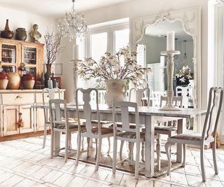 Wooden cabinet, white dining chairs, vase