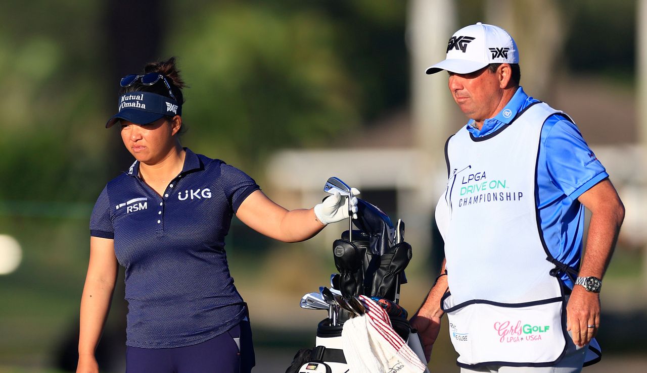 Megan Khang pulls a golf club out her bag during the 2024 LPGA Drive On Championship