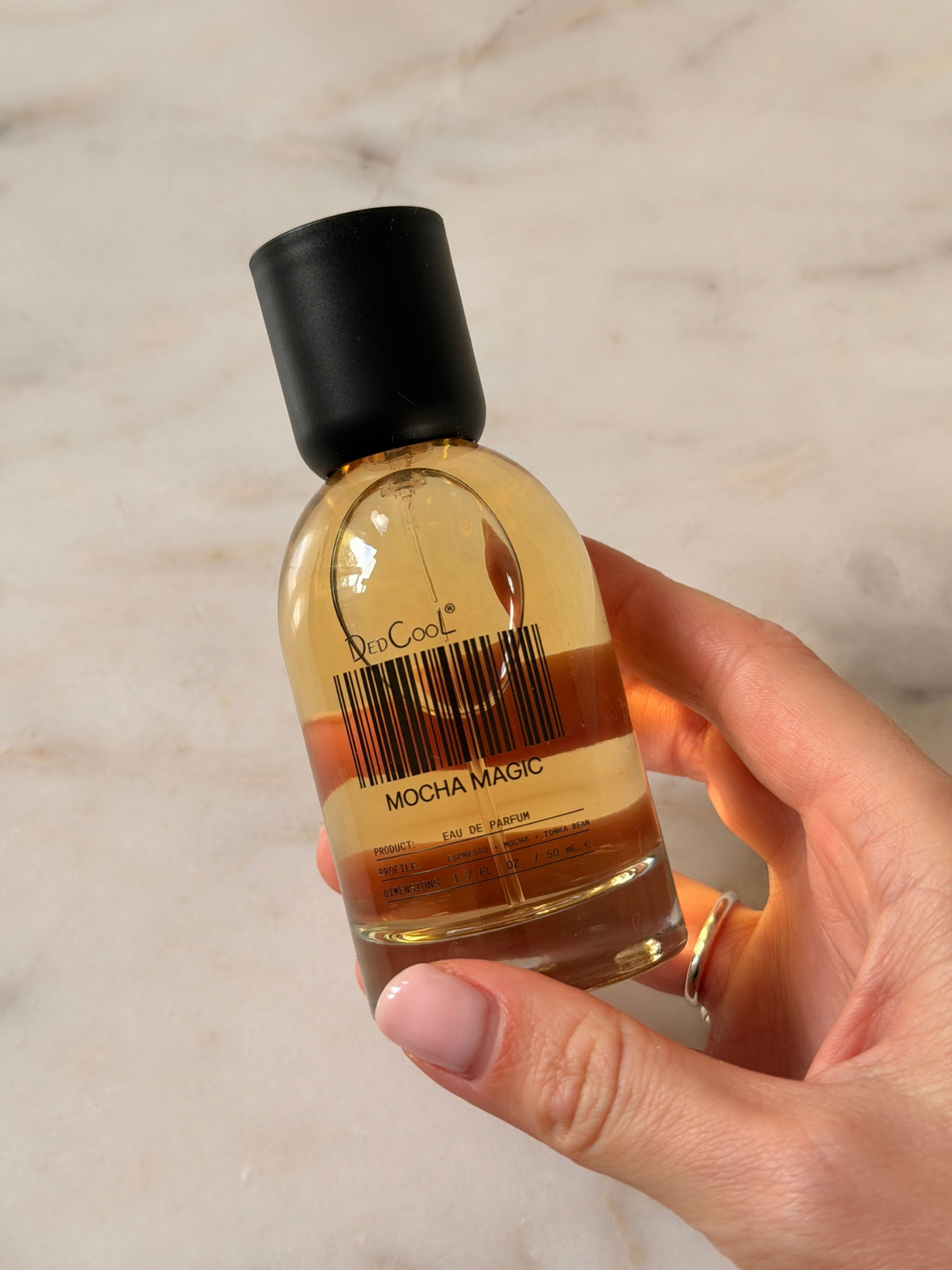 Freelance beauty editor Grace Day holding a bottle of DedCool Mocha Magic