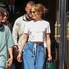 Jennifer Lopez walking down a street in Paris