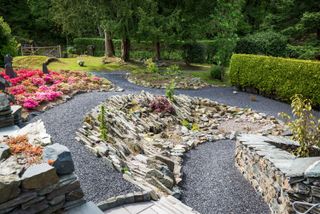 sloping garden ideas: modern take on a rockery garden in a sloping garden