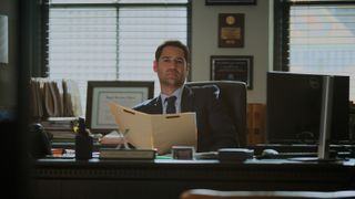 Manuel Garcia-Rulfo as Mickey Haller at his desk in The Lincoln Lawyer season 3 episode 8