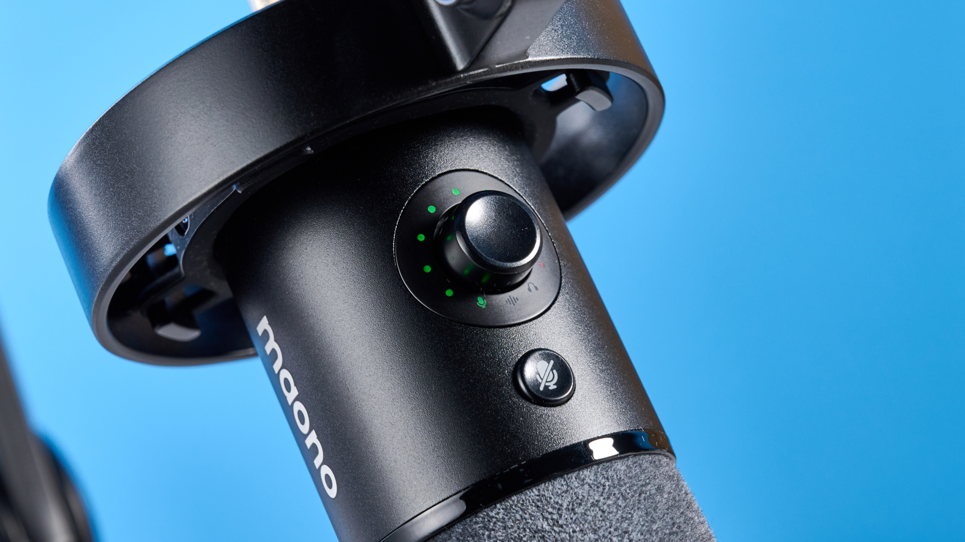 the maono pd1300x microphone for podcasting with an xlr and usbc connection and a boom arm in the photograph but also available with a desktop stand, one button dial on the mic and a muting button
