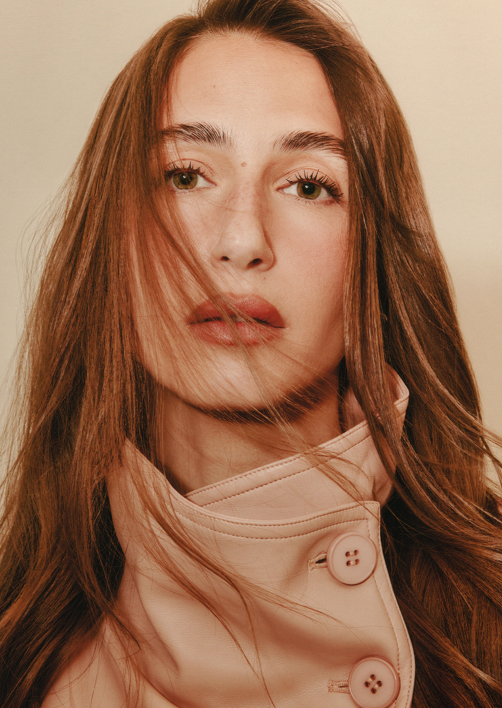 A close-up of Amanda Batula from 'Summer House' wearing a pink funnel-neck jacket