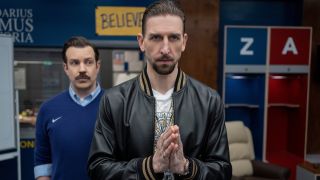 Zava making prayer hands in the AFC Richmond locker room while Ted Lasso stands behind him