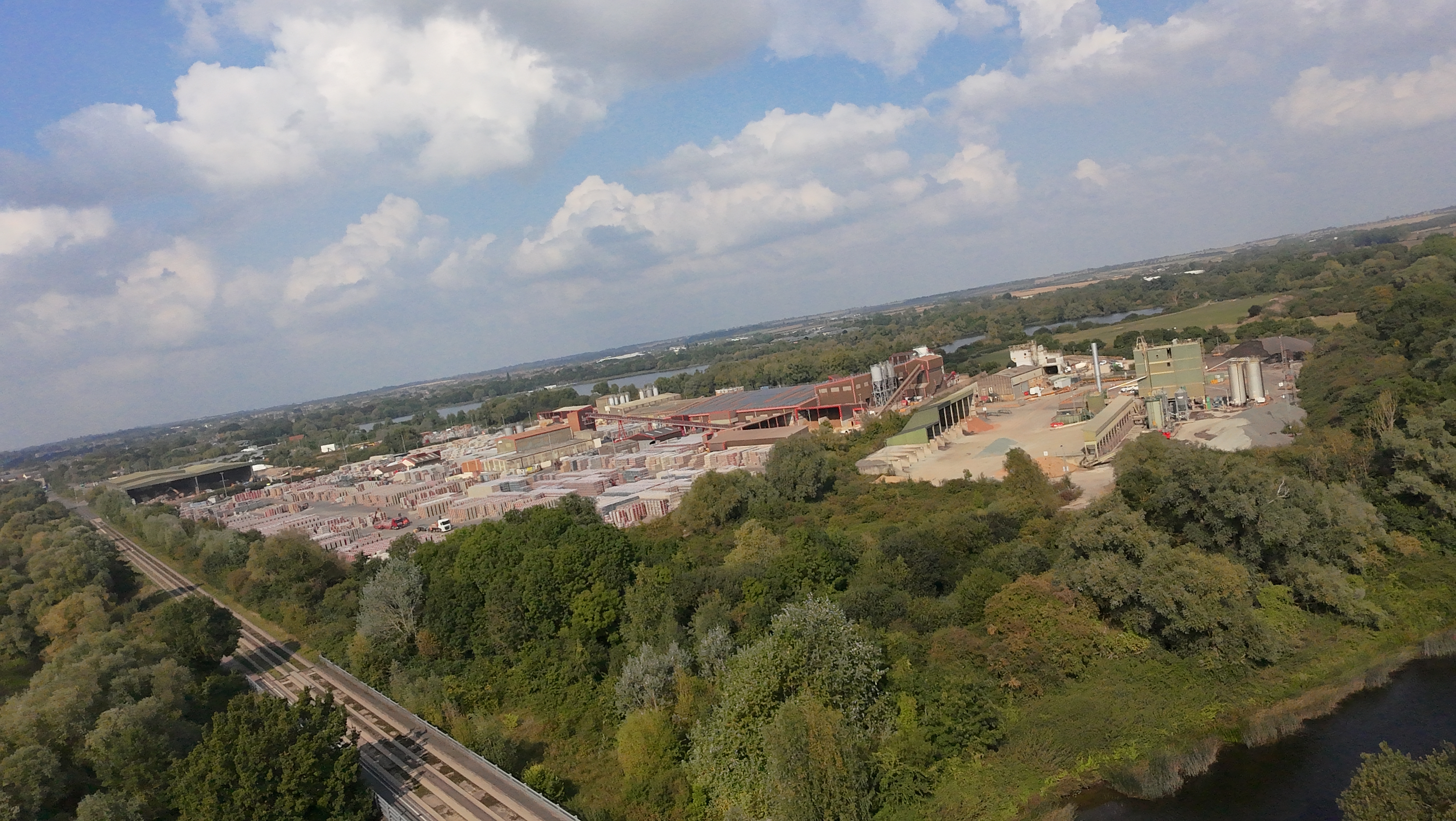 View of an industrial area fringed by trees taken by DJI Neo.