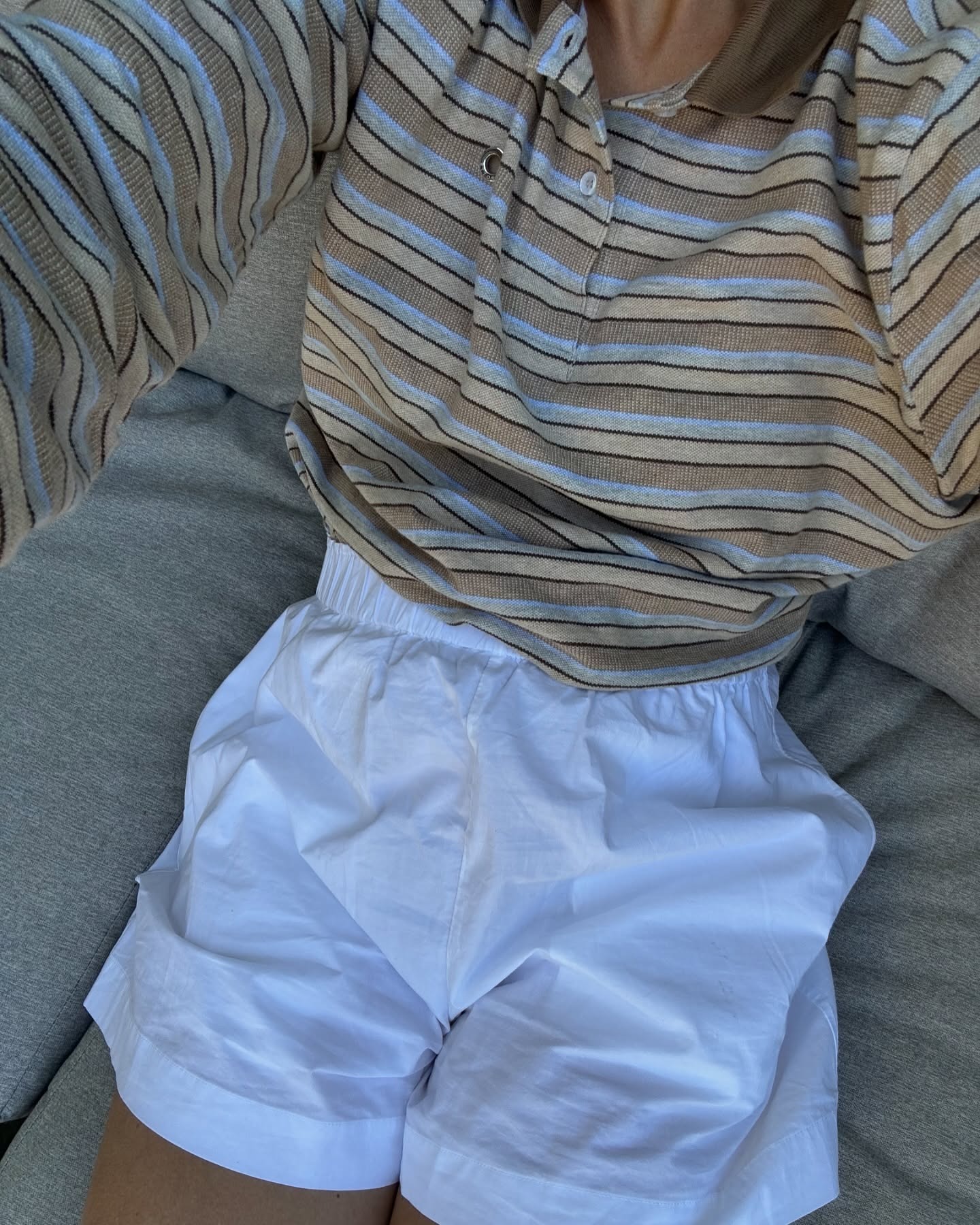 @lindatol_ wearing a striped long-sleeve shirt with boxer shorts.