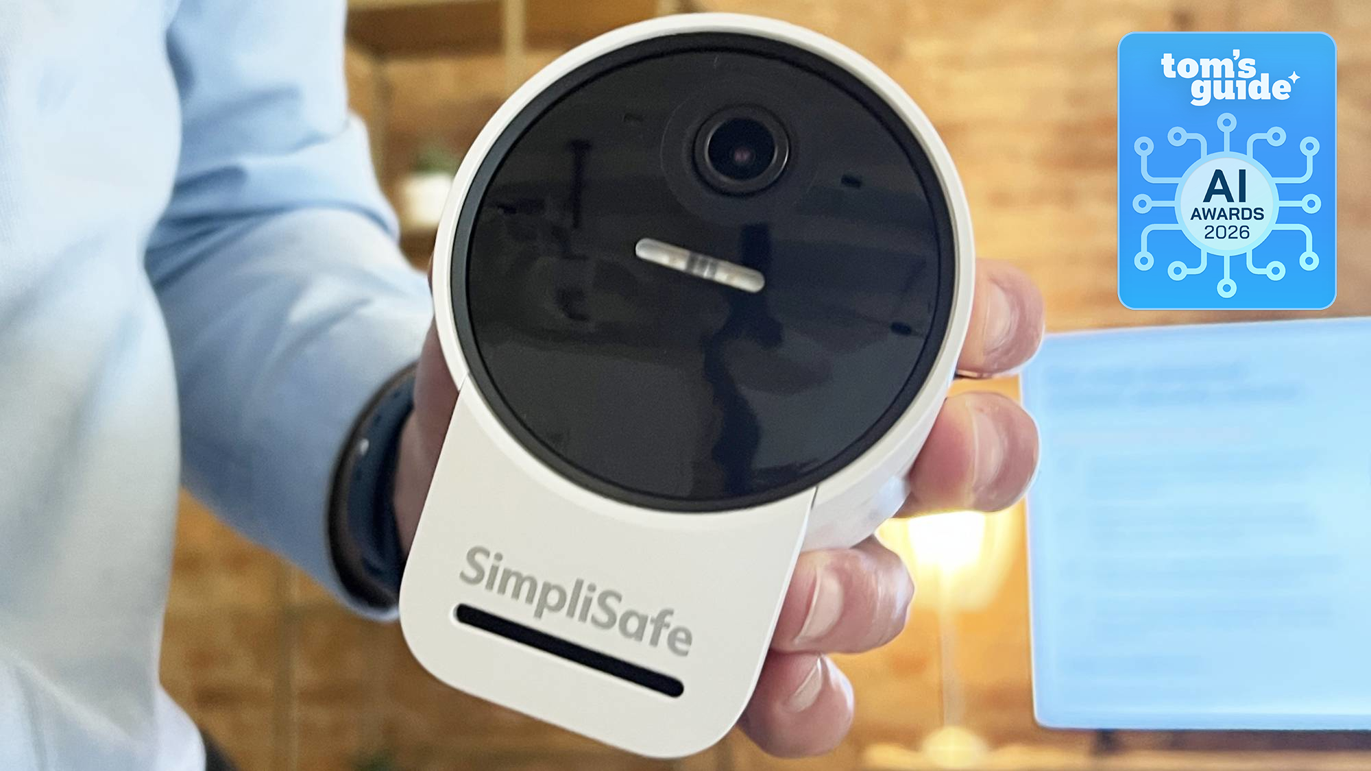 A SimpliSafe camera in hand with a Tom's Guide Awards 2026 badge