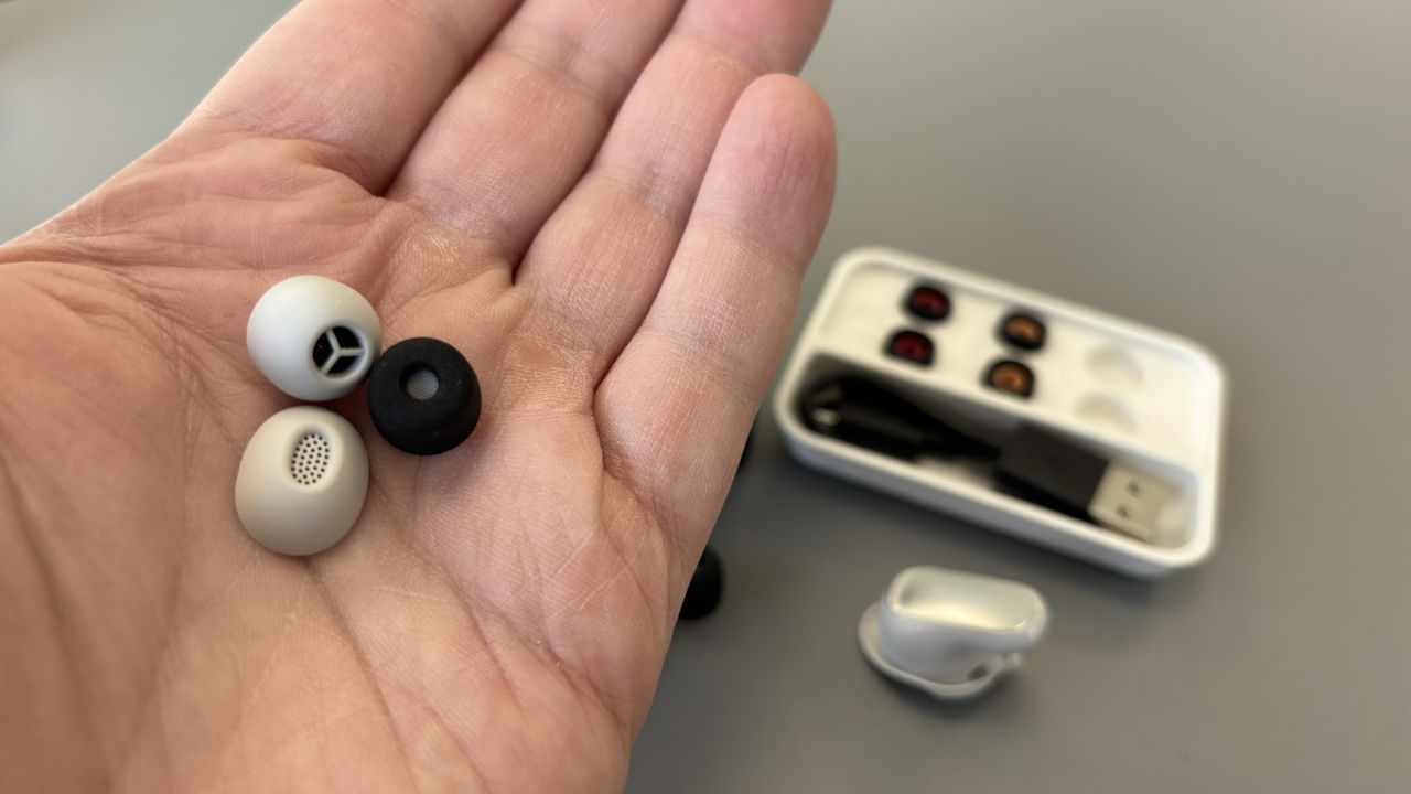 Sony WF-1000XM6 eartips being held in hand with Bose and Technics eartips