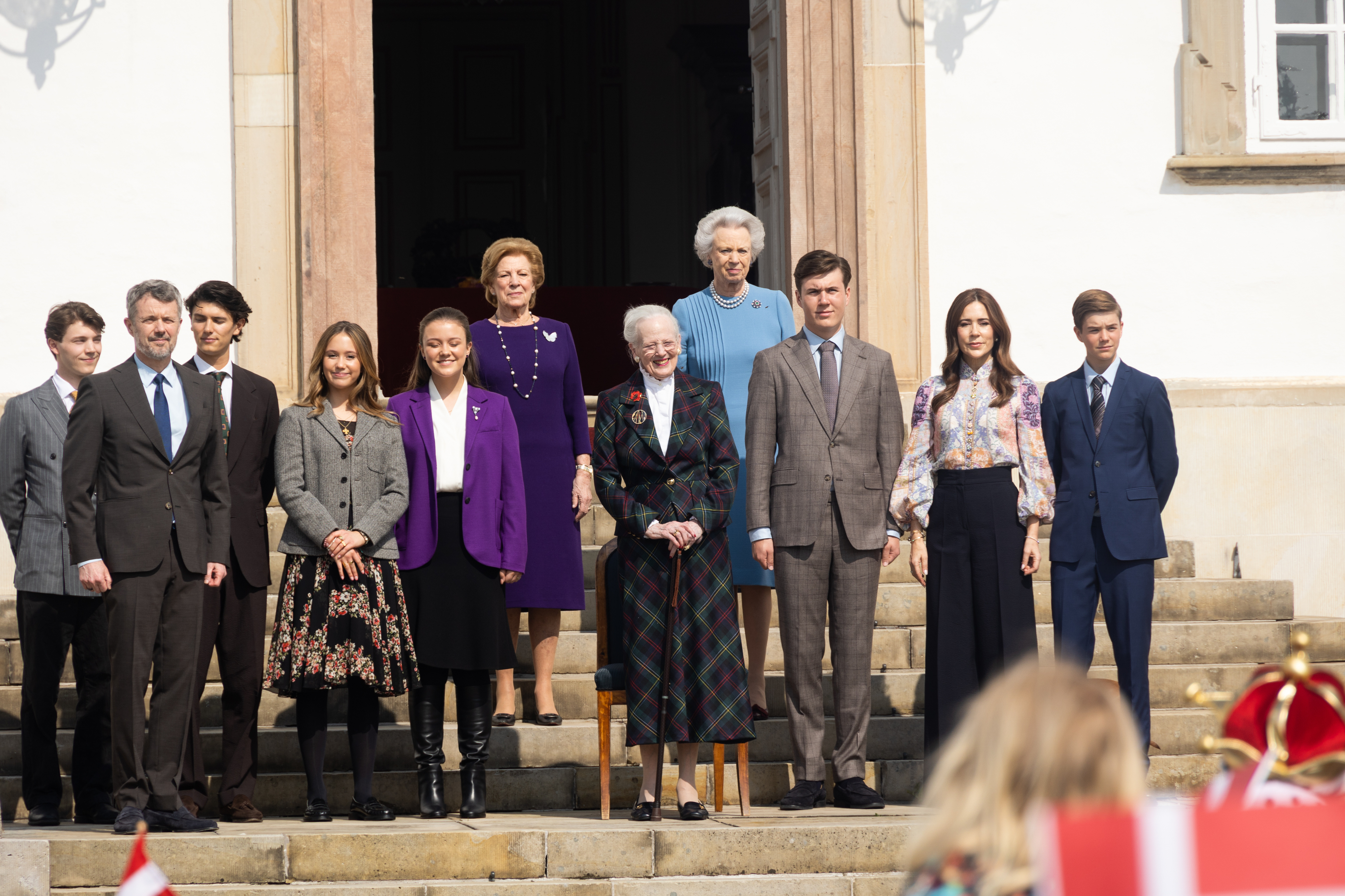 Queen Margrethe and members of the Danish royal family posing on steps for her 85th birthday